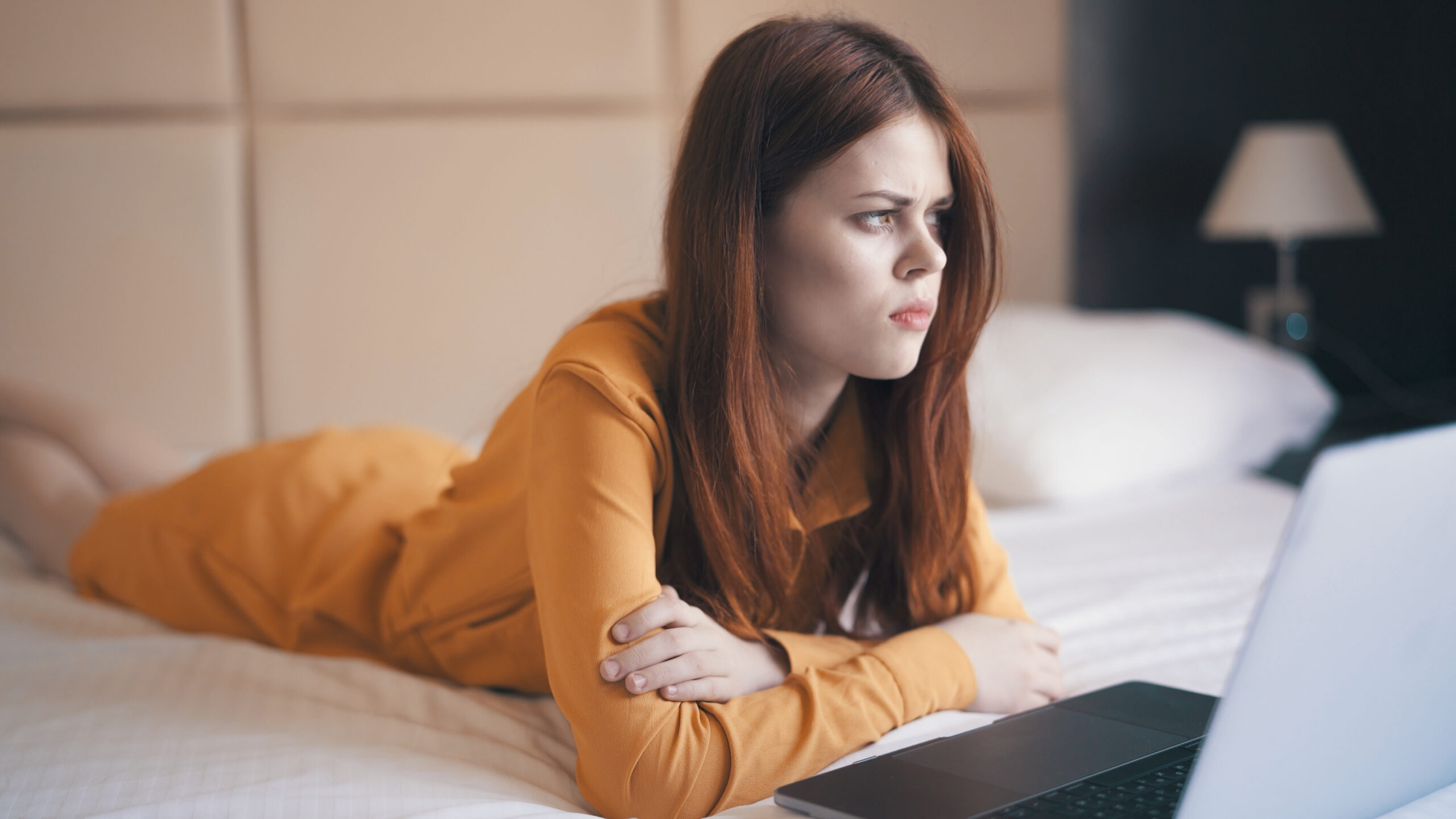 How to Spot Obsessive Ex-Girlfriend Behaviour Before It Goes Too Far - woman in bed on laptop