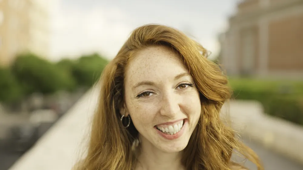 Smiling woman with strawberry blonde hair
